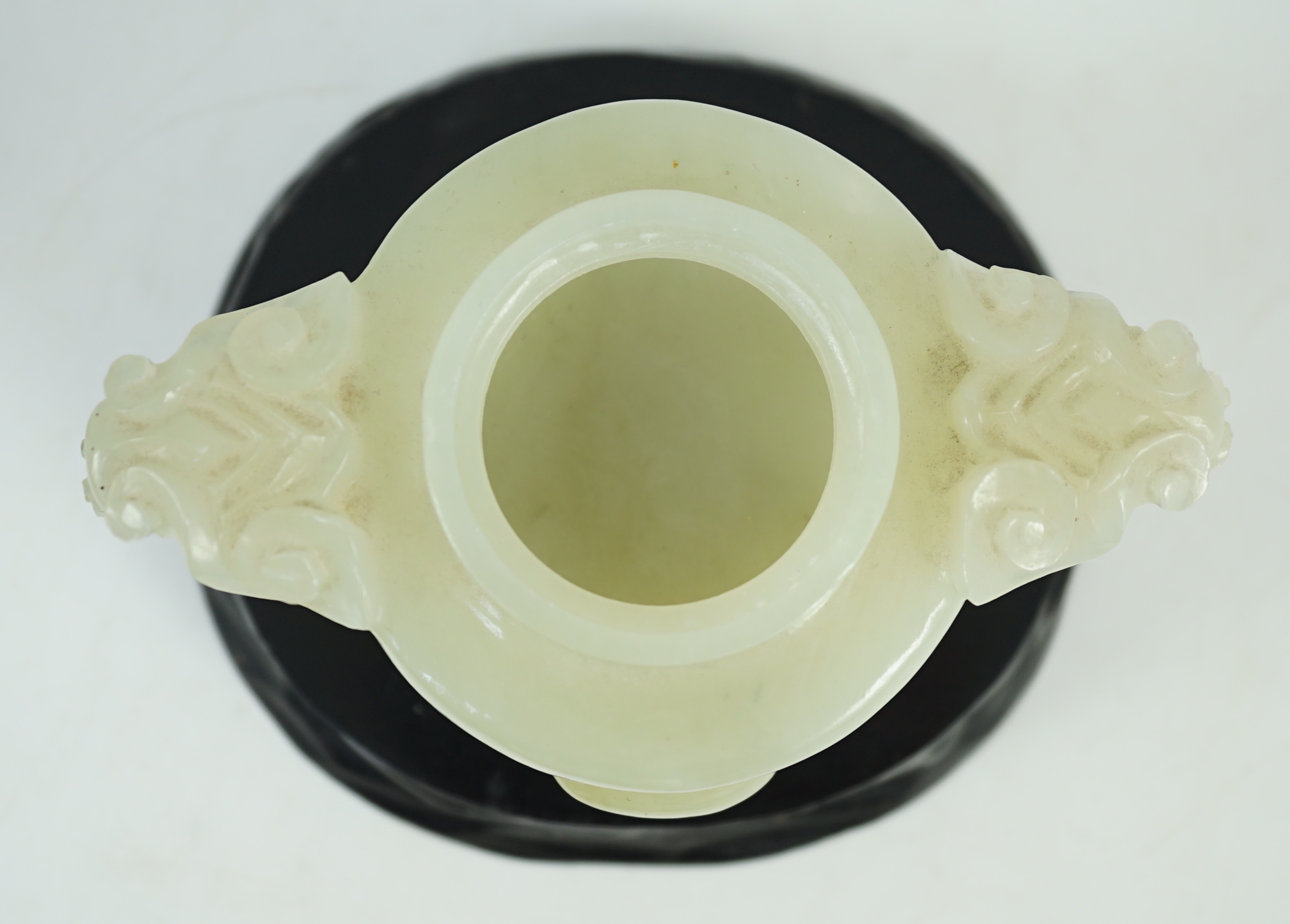 A Chinese pale celadon jade tripod censer cover, 20th century, 12cm wide, wood stand